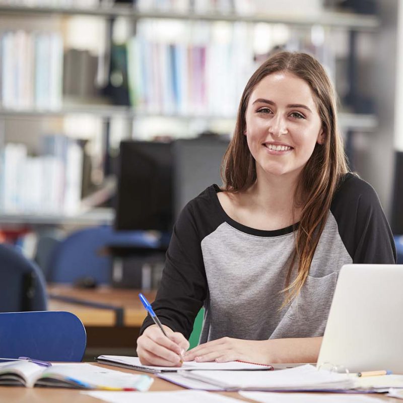 portrait-of-female-student-working-at-laptop-in-co-P5GWU9L.jpg